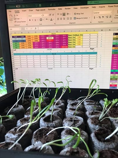How Angie keeps her seed starters organized. A black plastic seed starter tray along with a color coded excel worksheet.