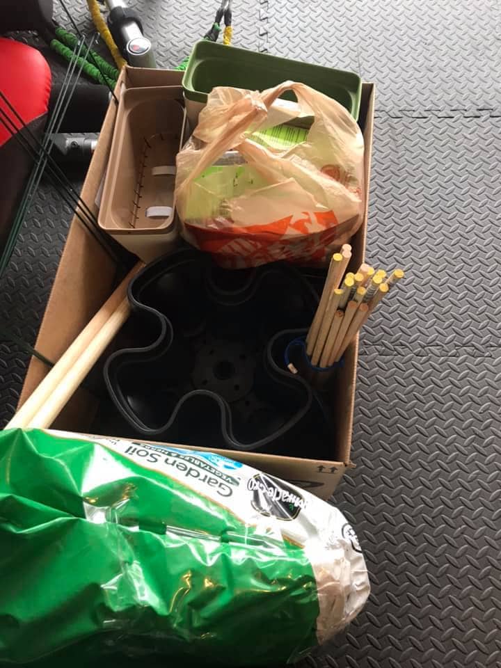 Garden supplies in a box - Mr. Stacky, dowel rods, dirt, planters and plants