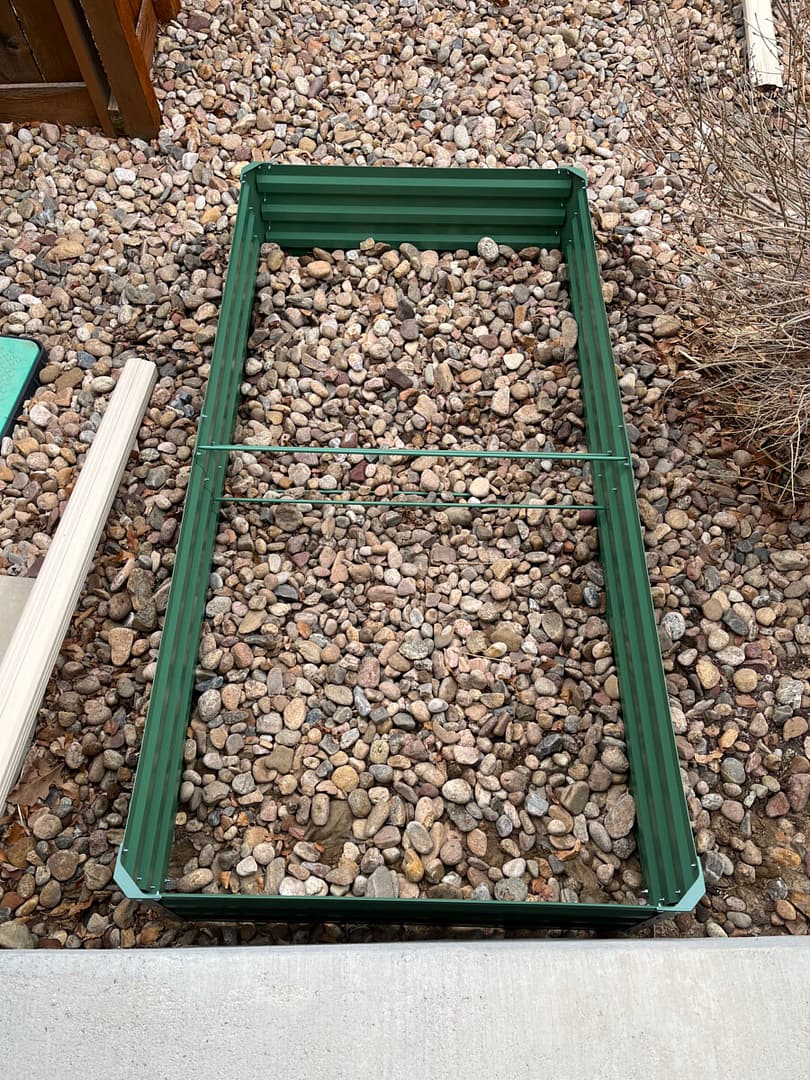 Angie shares How To Fill A Raised Garden Bed - this bed is green metal and needs to be filled with dirt..